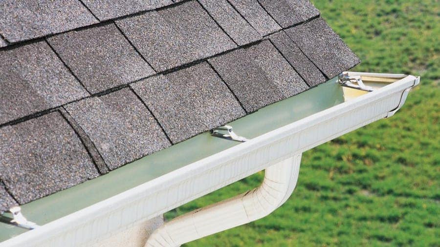 Our Services 6 Seamless aluminum gutter fitted along a shingle roof edge