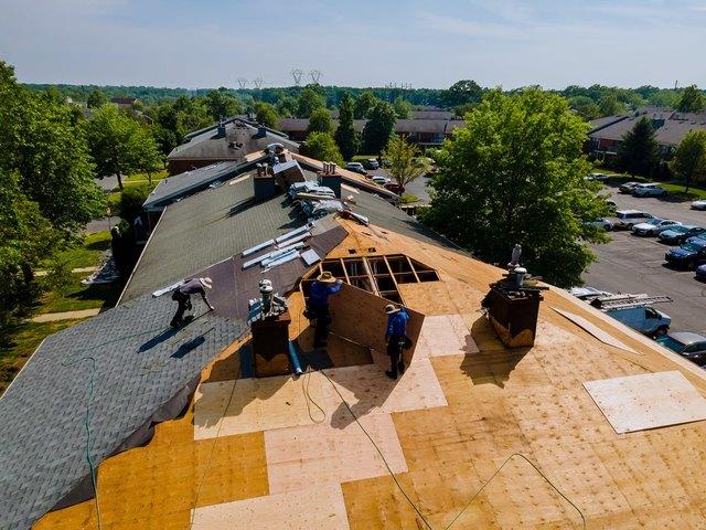 Our Services 3 DJJ Roofing crew replacing a roof with the decking exposed