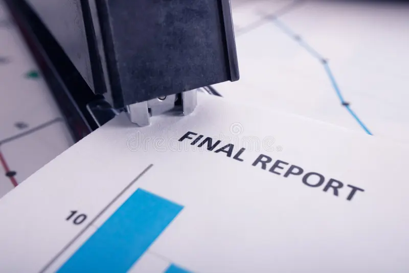 Insurance Claims 7 final report closeup stapler being used to bind pages together 84323755