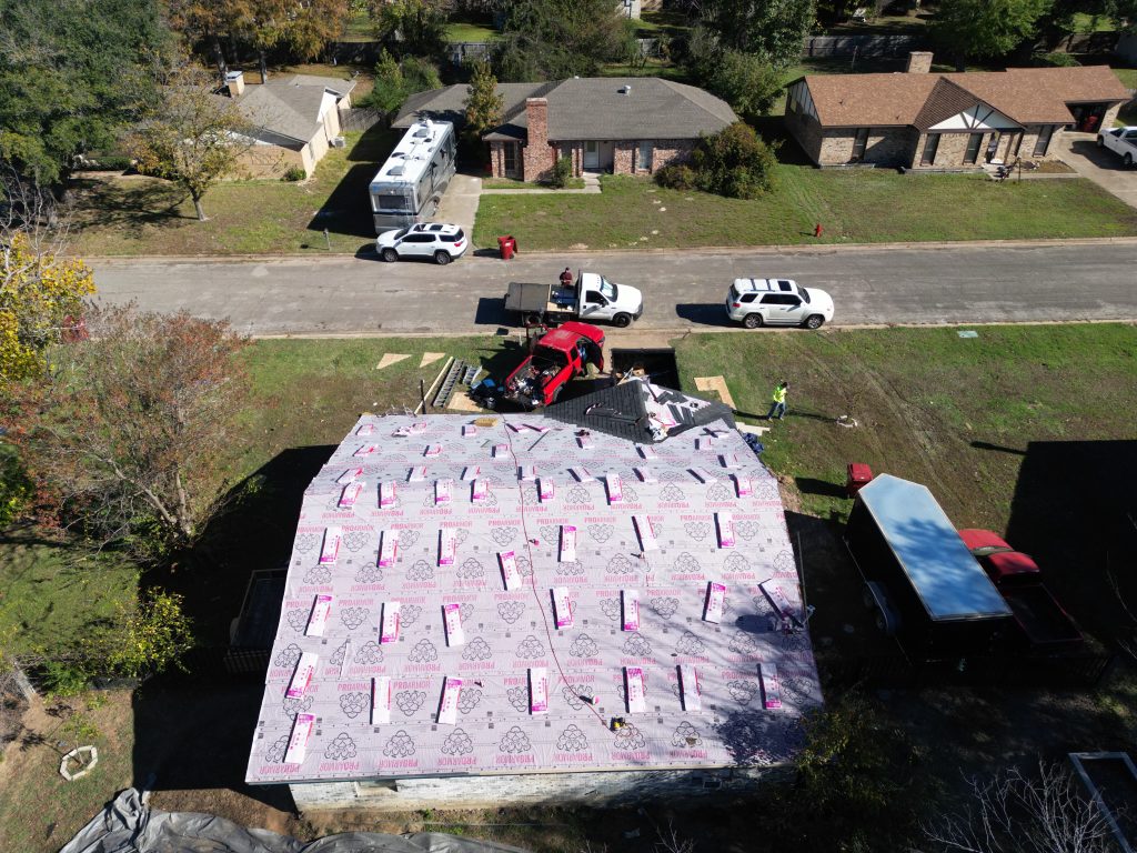 Roofing Contractor in Sulphur Bluff, TX 15 Roof tear-off in progress with the property protected below
