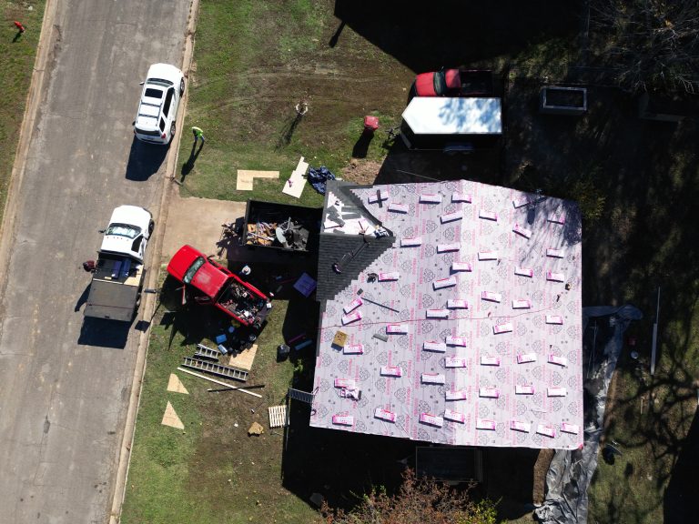 Roofing crew installing underlayment on a Northeast Texas home