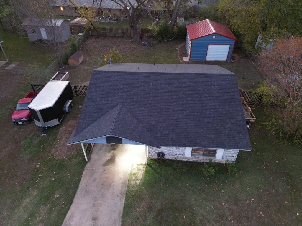 Asphalt Shingles 6 Completed dark asphalt shingle roof on a stone home in Northeast Texas