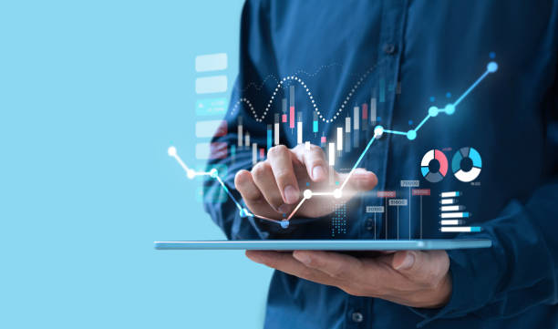 Roof Financing 2 Person reviewing business growth charts on a tablet