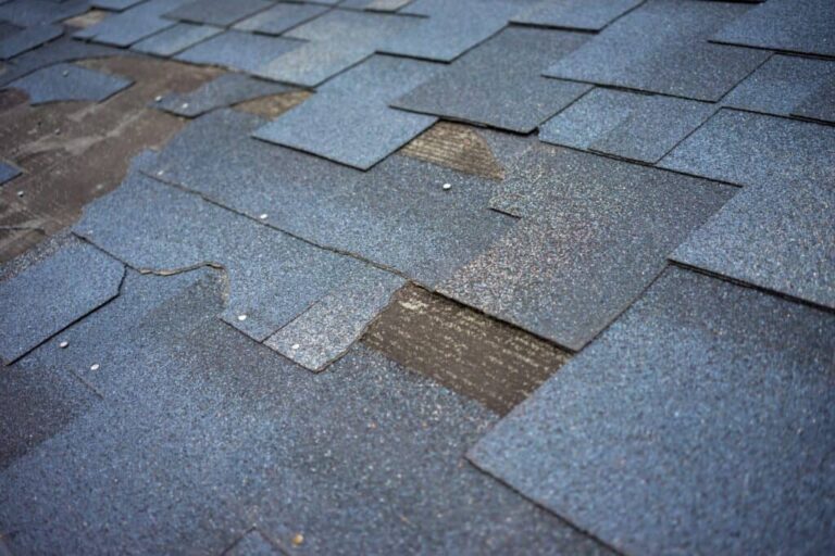 Signs your roof needs to be replaced: a severely damaged shingle roof in Texas