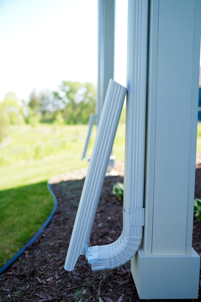 Downspout and extension carrying water away from a foundation