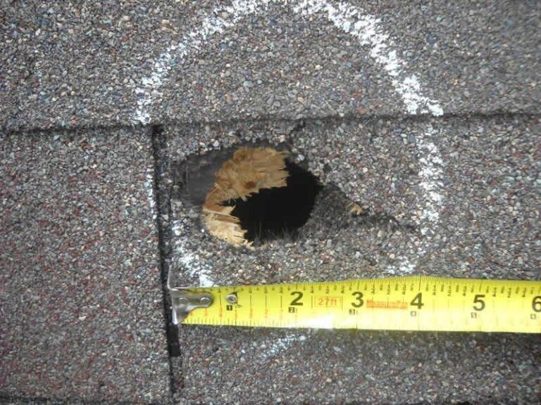 A puncture in a roof measured with a tape during an inspection