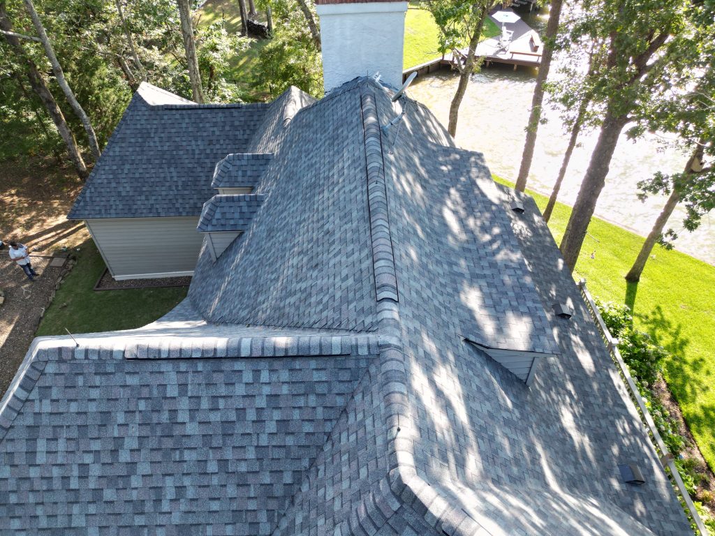 Aerial view of a gray shingle roof showing dormers and valleys
