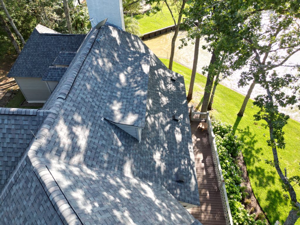Roof Inspection in Emory, TX 6 Aerial view of the peak and valleys of a gray architectural shingle roof