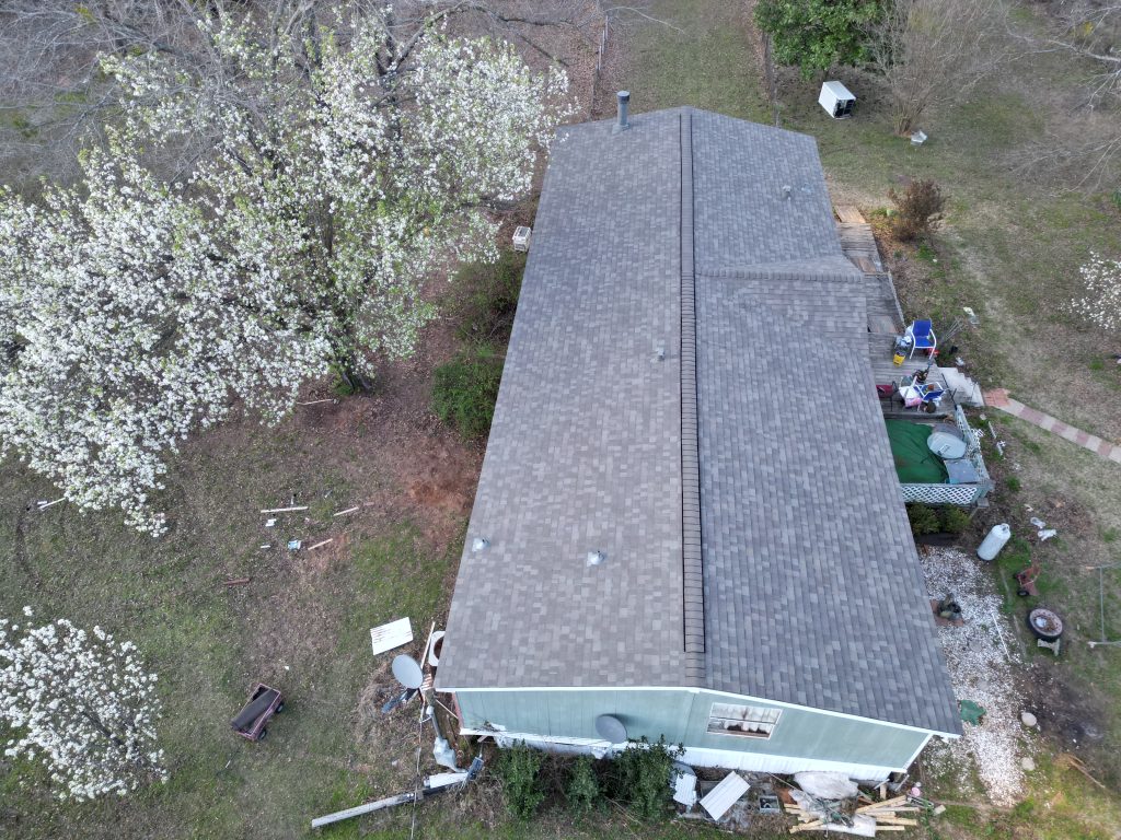 Completed shingle roof on a manufactured home near Como, Texas, seen along its length