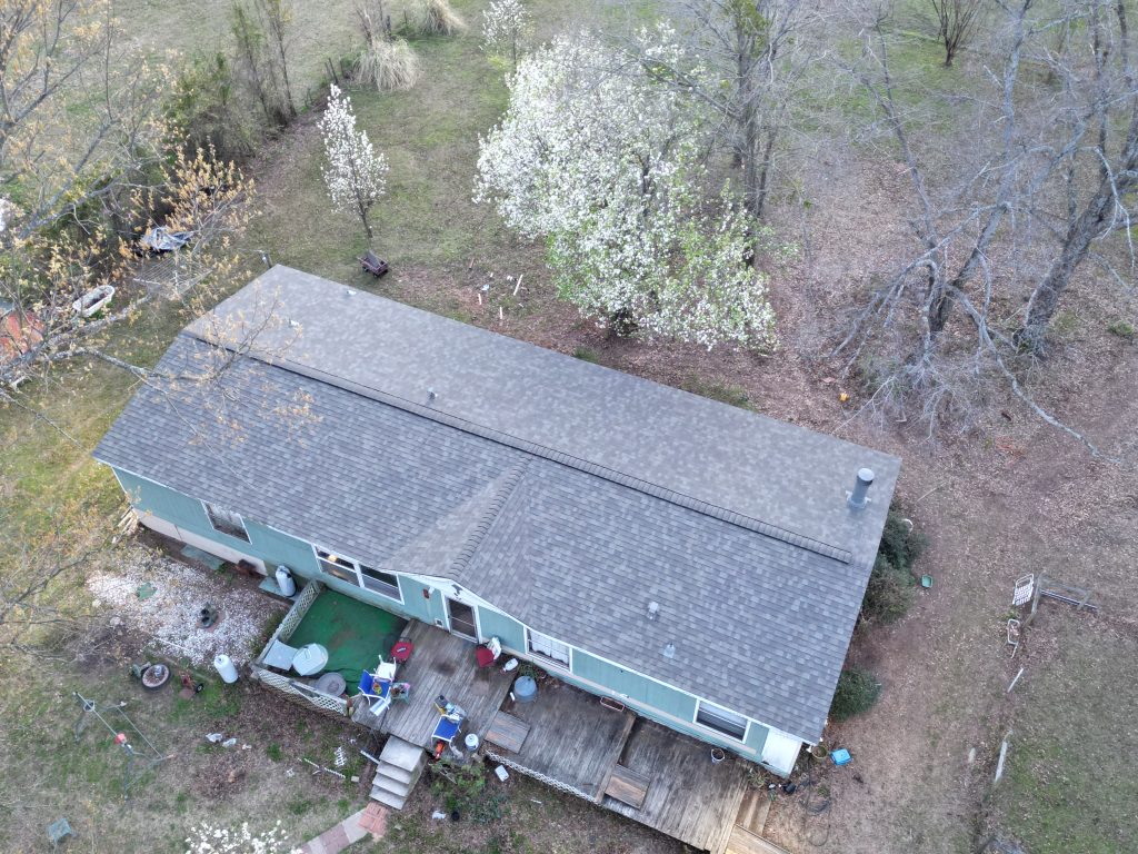 Completed shingle roof and rear elevation of a home near Como, Texas