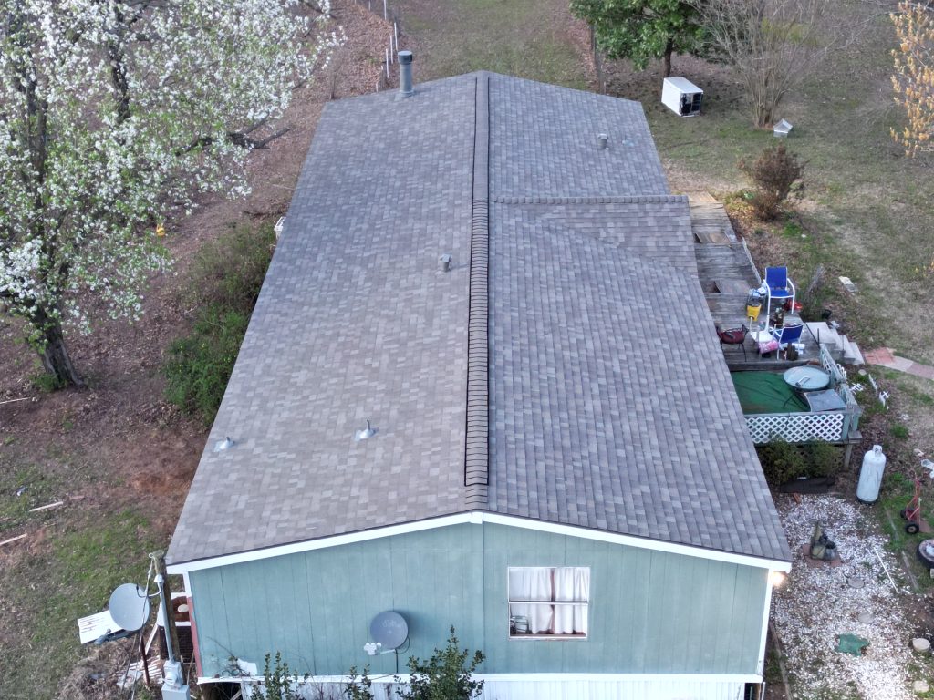 Pipe boots and ridge cap on a completed shingle roof near Como, Texas