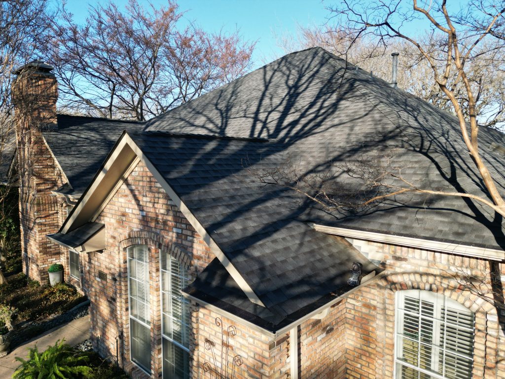 Gable and chimney on a finished shingle roof in Greenville, Texas