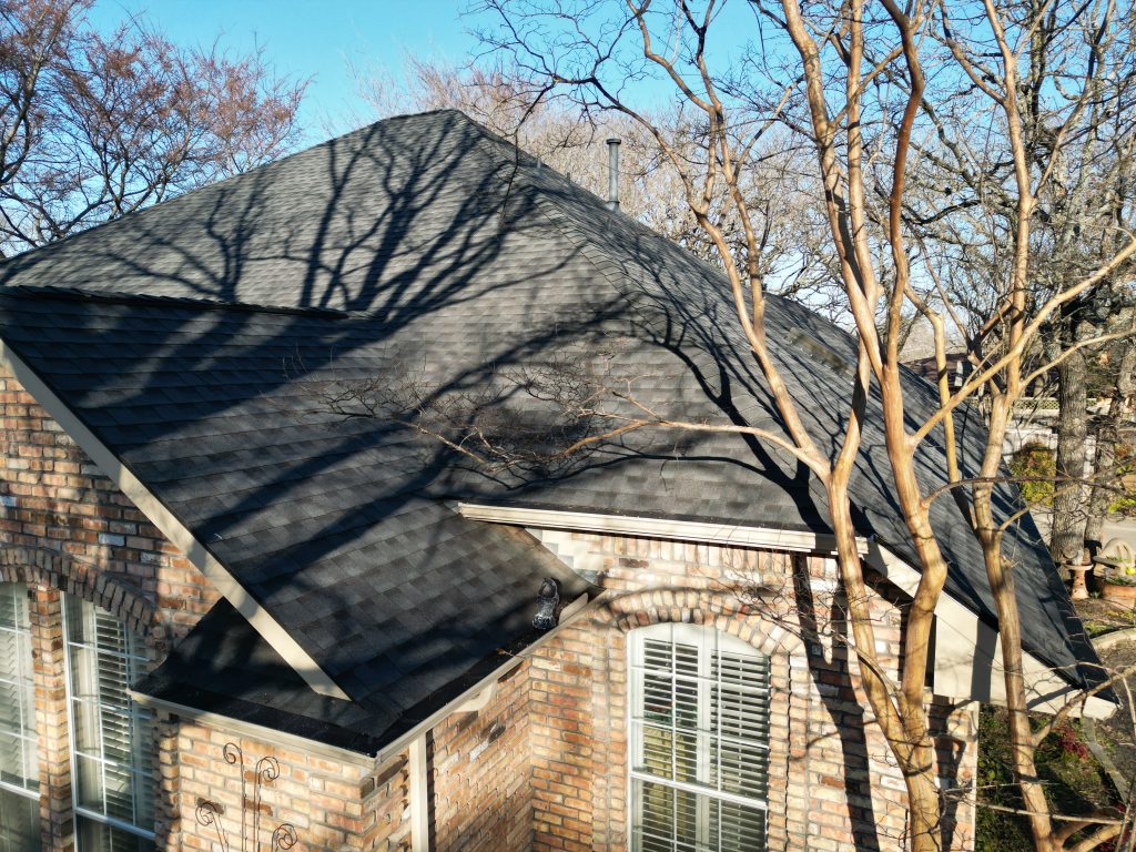 Finished shingle roof on a brick home in Greenville, Texas