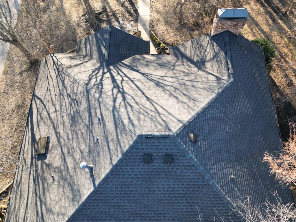 Ridge, hips and vents on a finished shingle roof in Greenville, Texas